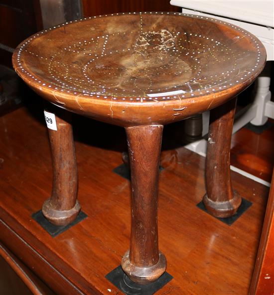 A West African tribal hardwood and beadwork stool(-)